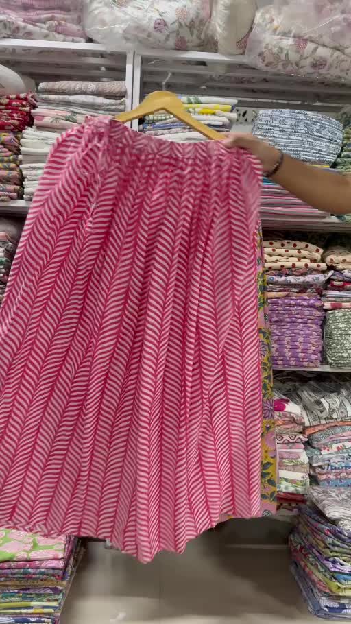 A pink printed garment shown on a hanger