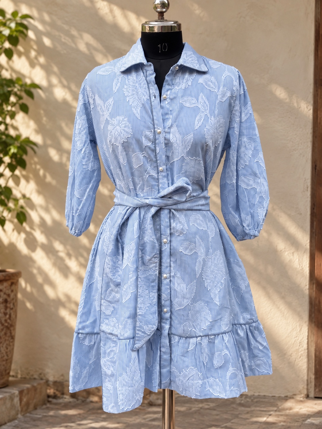 Blue striped floral dress on a mannequin