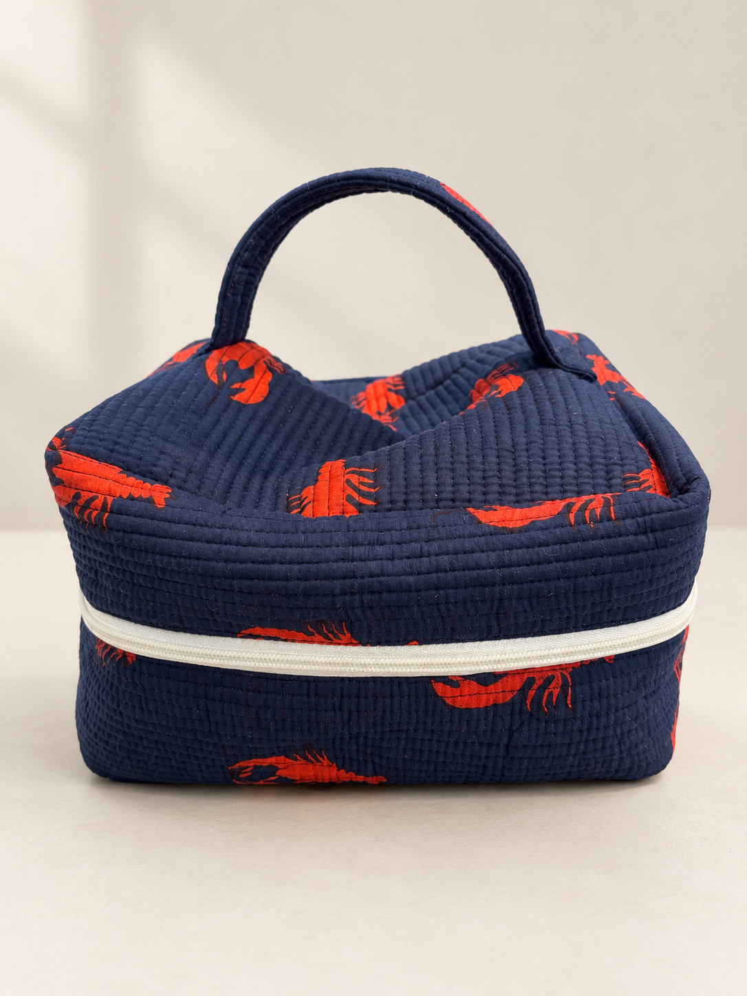 Navy quilted vanity bag with orange lobster print
