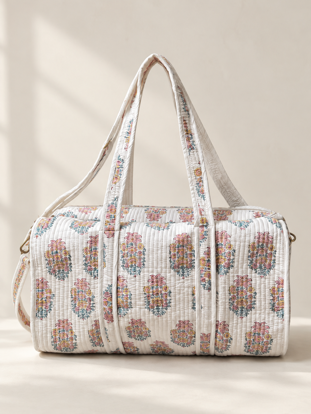 White floral quilted duffel bag